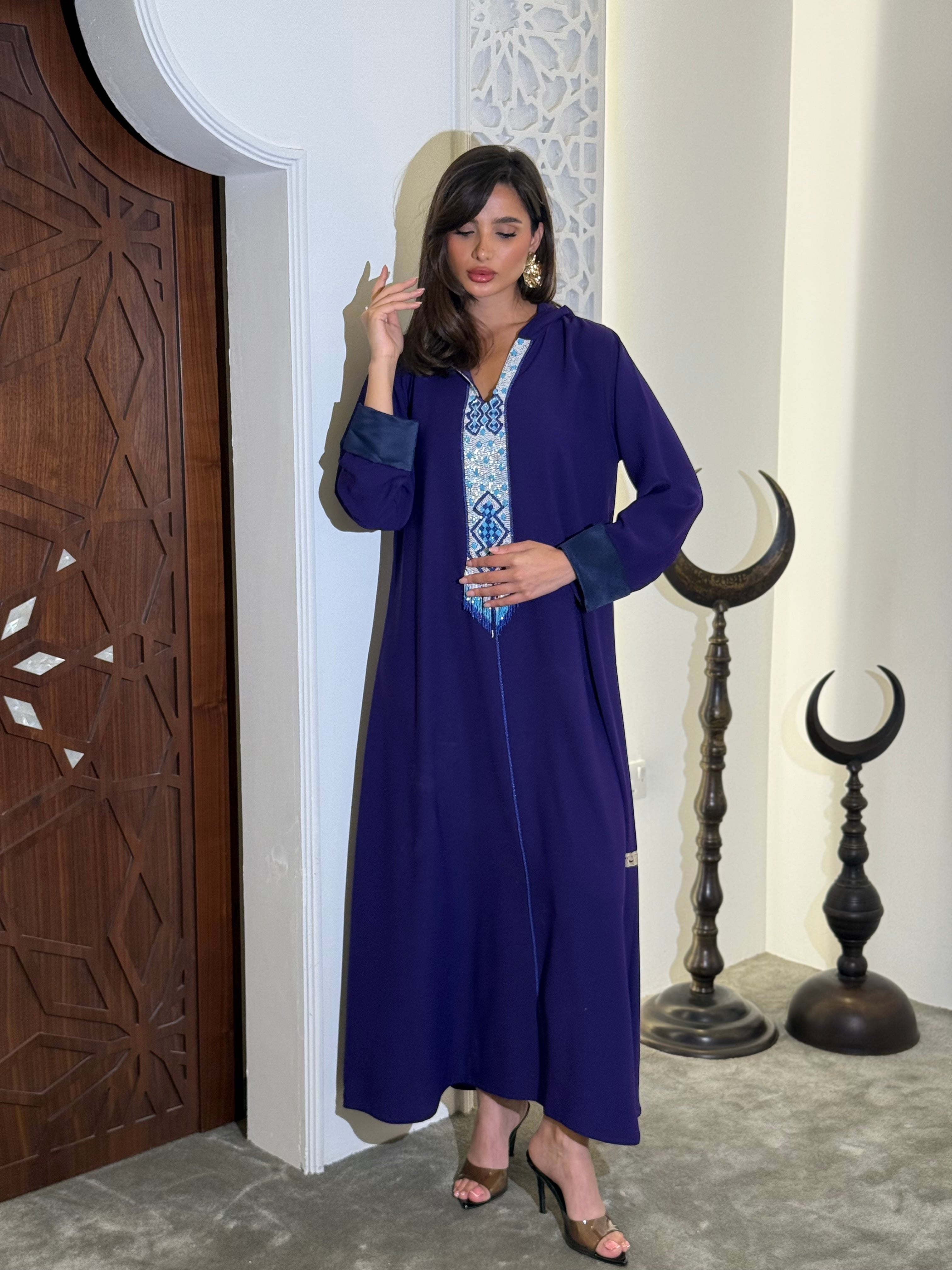 جلابيات من الكريب بلونين، بنفسجي داكن مع تفاصيل زرقاء، تتميز بتطريز دقيق بالخرز (على الطلب)