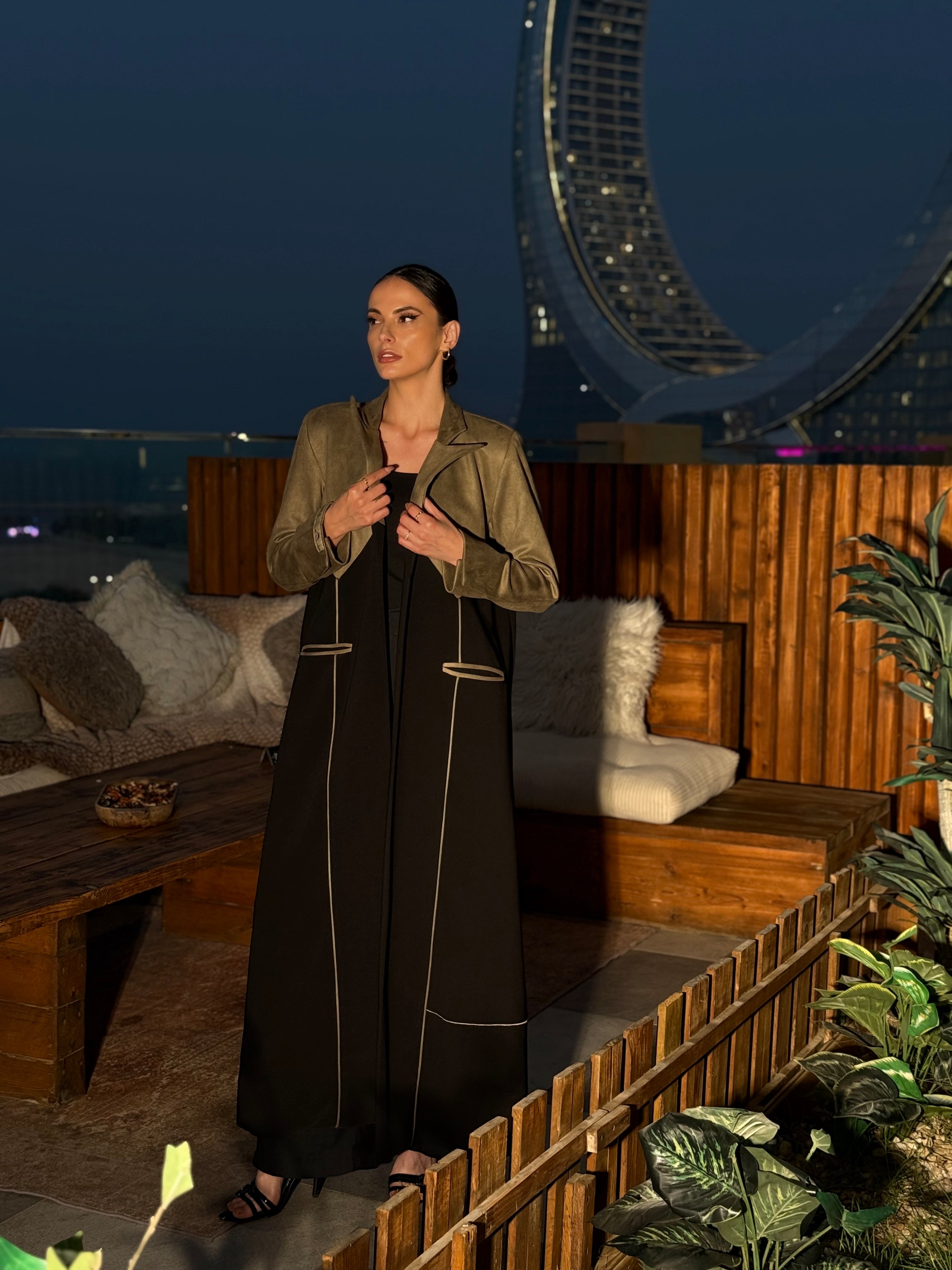 A winter blazer with structured padded shoulders, crafted from heavy crepe fabric and finished with suede accents.